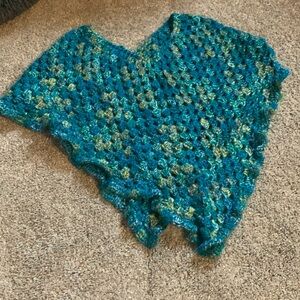 This can be a great swimsuit cover up or poncho and is hand made.